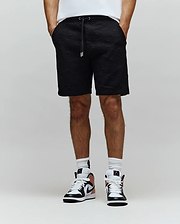 Mens Dustin Sweatshort in black, featuring a relaxed fit and an all-over embossed Psycho Bunny skull pattern, complete with a black drawstring and silver tips.