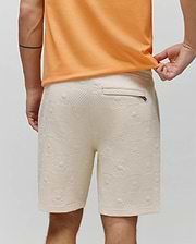 Mens Dustin Sweatshort in cream jacquard knit, featuring a relaxed fit and an all-over pattern of small Psycho Bunny skull logos and textured squares.