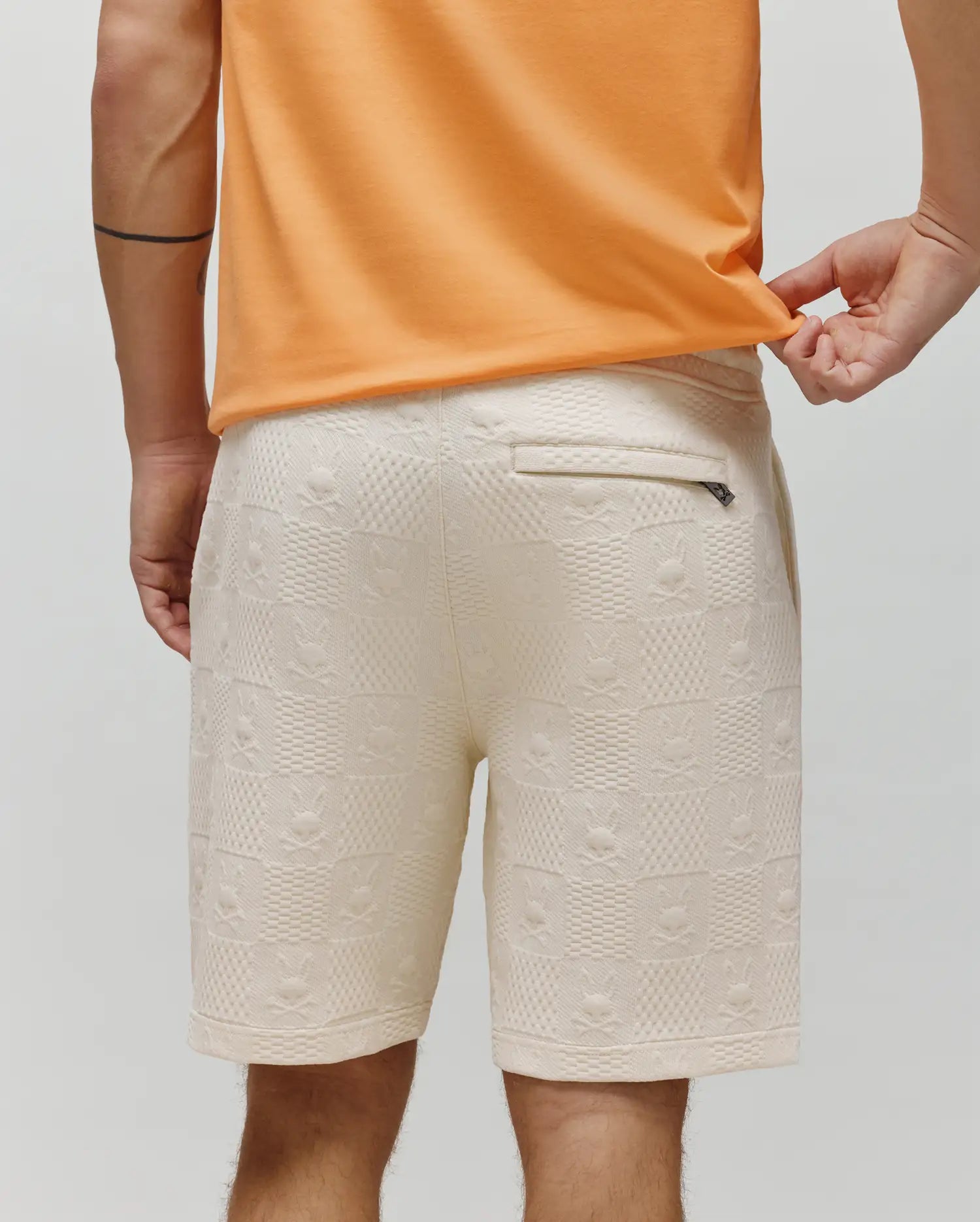 Mens Dustin Sweatshort in cream jacquard knit, featuring a relaxed fit and an all-over pattern of small Psycho Bunny skull logos and textured squares.