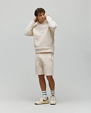 Mens Dustin Sweatshort and matching relaxed fit cream hoodie, both with an allover embossed Psycho Bunny skull logo pattern. Small embroidered bunny logo on hoodie chest, black drawstring tips.