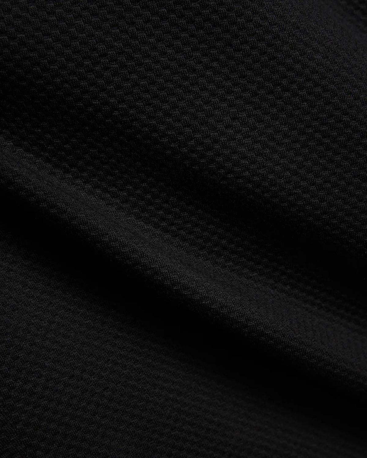 Mens Marc Textured Short in deep black, showcasing a premium, refined streetwear fabric with a distinctive, subtle geometric textured knit pattern, embodying Psycho Bunny's bold style.