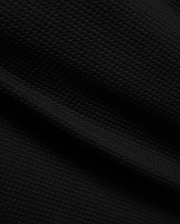 Mens Marc Textured Short in deep black, showcasing a premium, refined streetwear fabric with a distinctive, subtle geometric textured knit pattern, embodying Psycho Bunny's bold style.