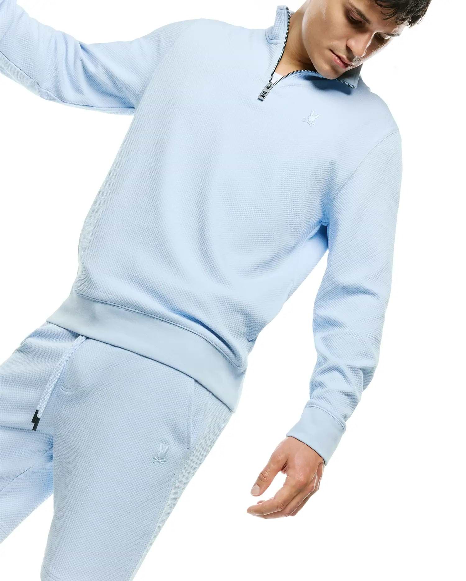 Light blue waffle knit quarter-zip sweatshirt featuring a tonal embroidered Psycho Bunny skull logo on the chest, paired with matching Mens Marc Textured Short with a tonal bunny skull logo on the left thigh.