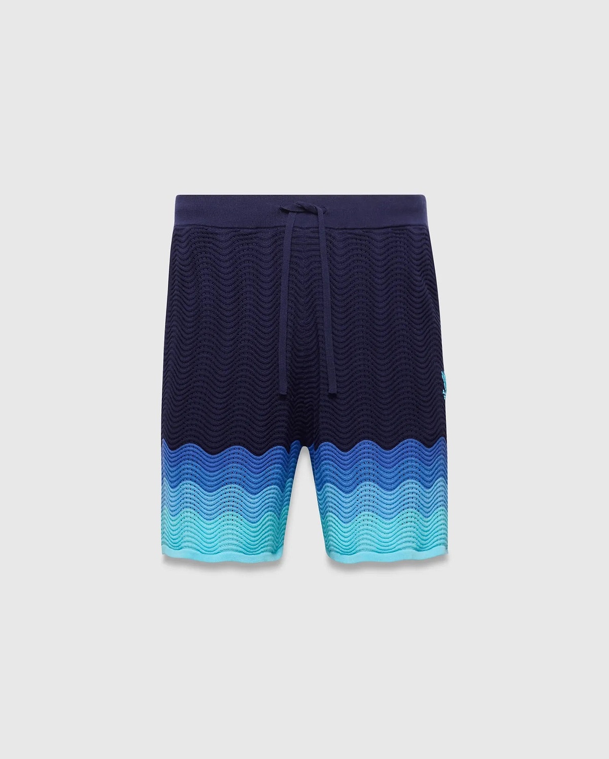 Holden Knit Short 6, navy relaxed fit shorts with a wavy knit texture, transitioning to blue and teal gradient, drawstring waist, and small embroidered Psycho Bunny skull logo on left leg. (5)