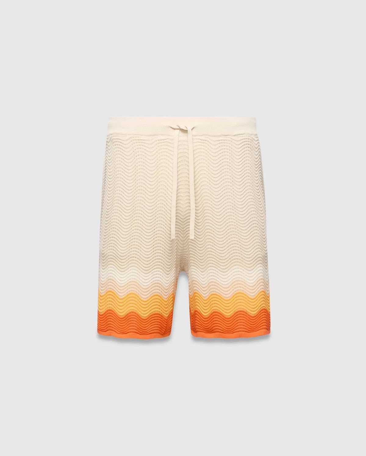 Mens Holden Knit Short in cream with a wavy knit texture, featuring a relaxed fit, drawstring waist, and a vibrant orange and yellow gradient stripe pattern at the hem.