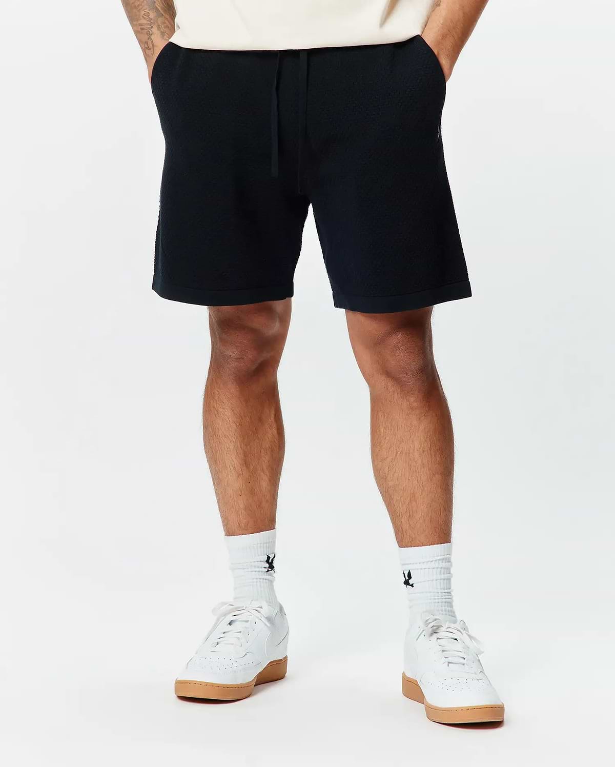 Mens Devon Knit Short, a premium black textured knit short from Psycho Bunny, featuring a comfortable relaxed fit, subtle geometric pattern, and an adjustable drawstring waist for refined streetwear style.