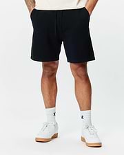 Mens Devon Knit Short, a premium black textured knit short from Psycho Bunny, featuring a comfortable relaxed fit, subtle geometric pattern, and an adjustable drawstring waist for refined streetwear style.