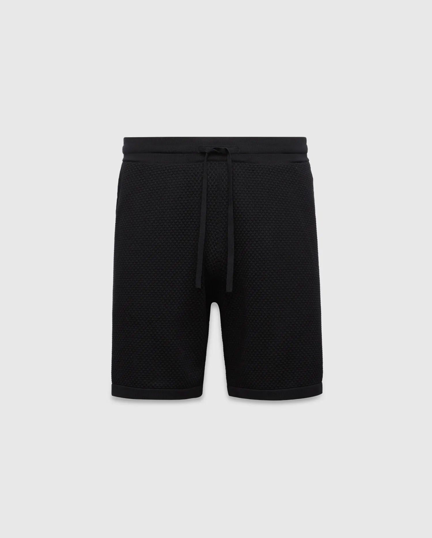 Black MENS DEVON KNIT SHORT with a relaxed fit, featuring a textured knit fabric, ribbed waistband, and drawstring closure. No visible Psycho Bunny logo.