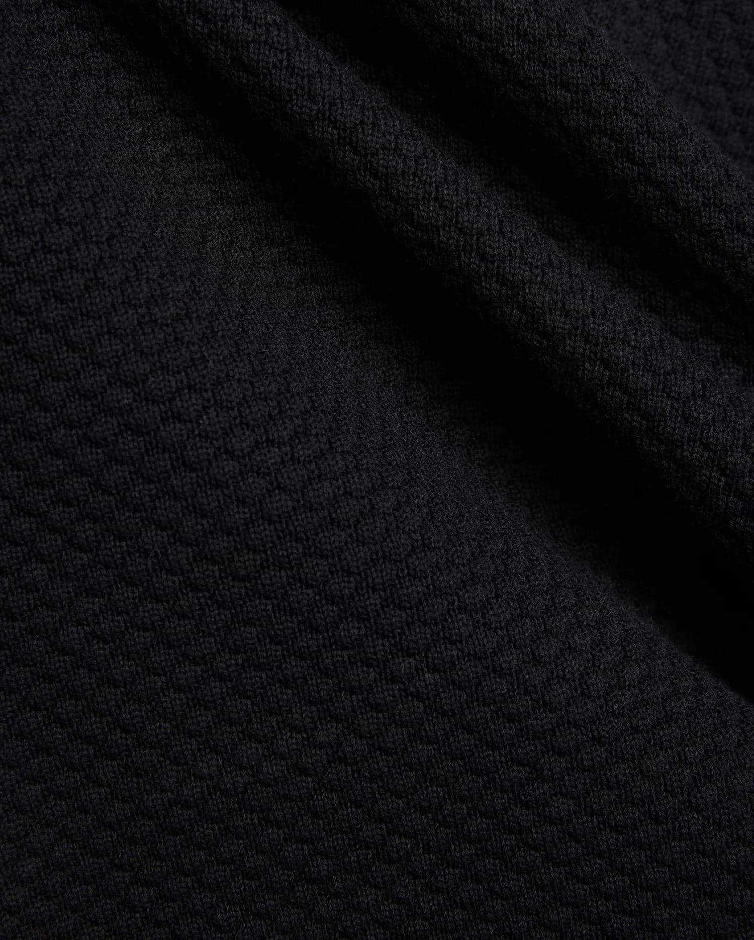Mens Devon Knit Short in rich black, showcasing a premium, subtly textured knit fabric with a refined mini-waffle pattern, embodying sophisticated streetwear style.