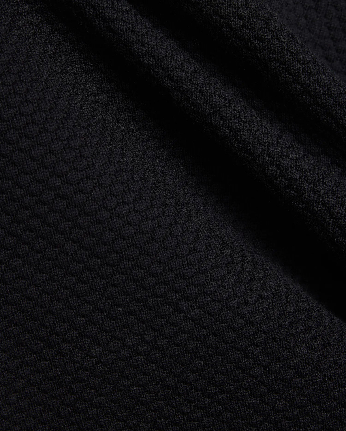Mens Devon Knit Short in rich black, showcasing a premium, subtly textured knit fabric with a refined mini-waffle pattern, embodying sophisticated streetwear style.