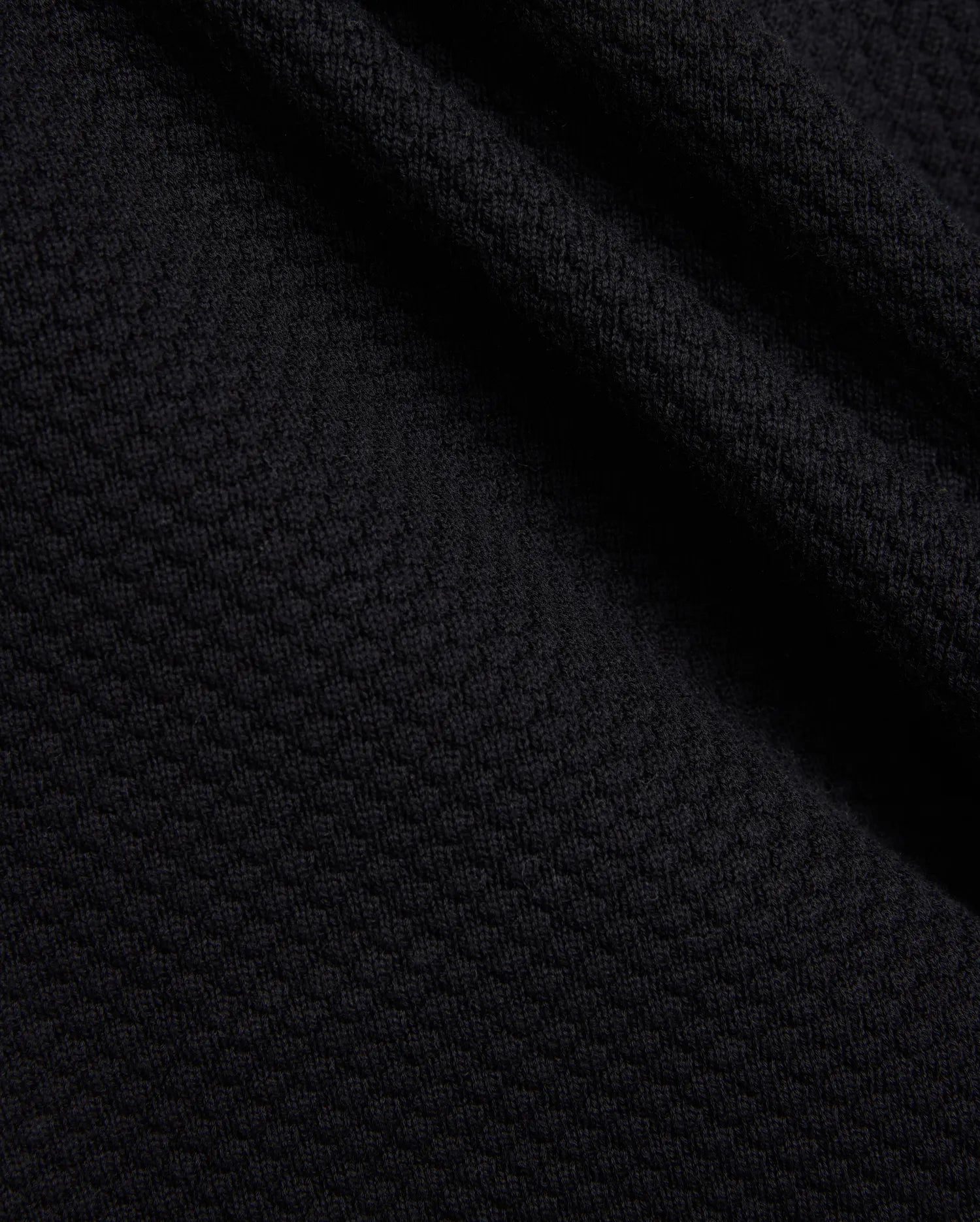 Mens Devon Knit Short in rich black, showcasing a premium, subtly textured knit fabric with a refined mini-waffle pattern, embodying sophisticated streetwear style.