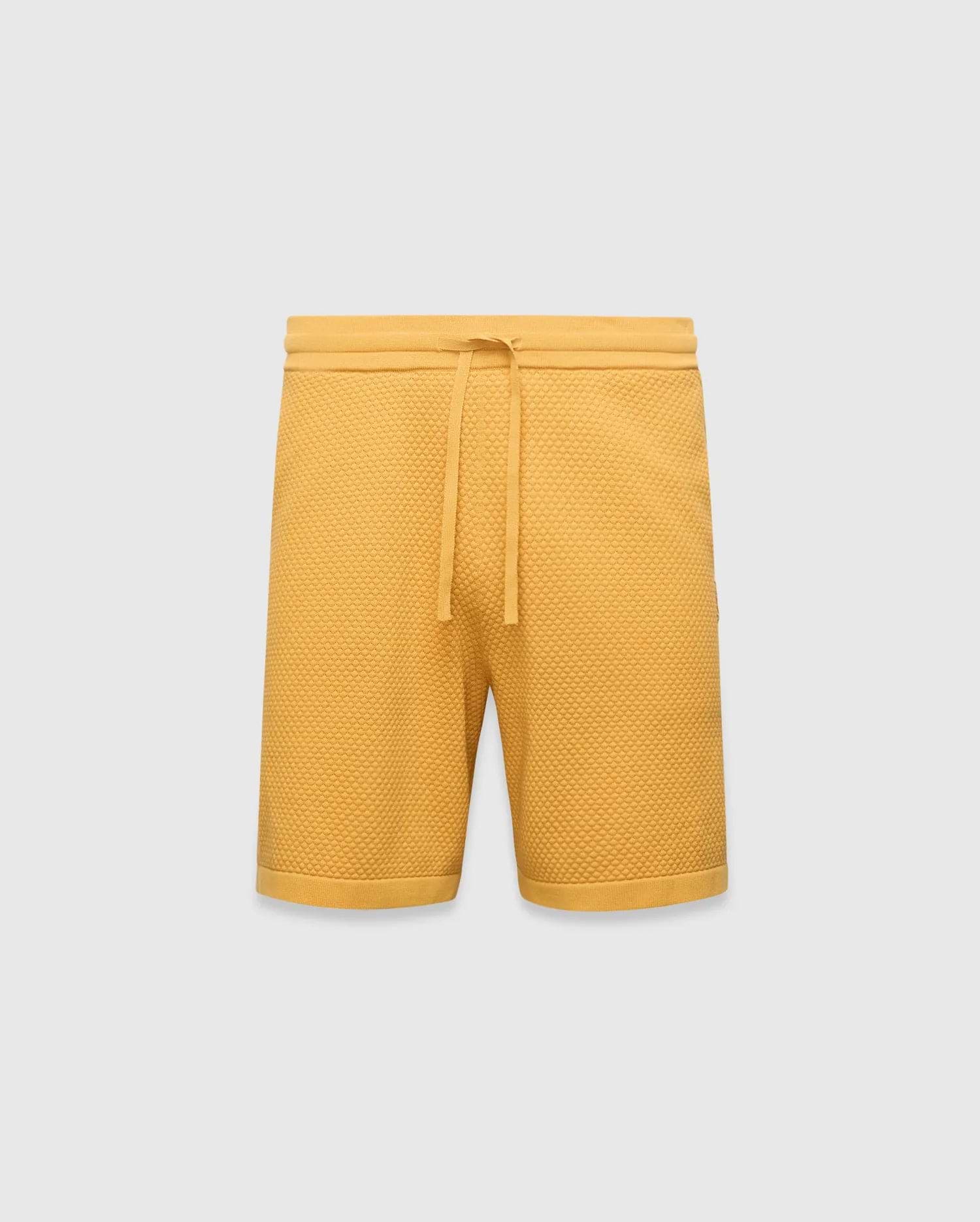 Mustard yellow Mens Devon Knit Short, a relaxed fit, premium textured waffle knit short with an adjustable drawstring waist and ribbed hem.