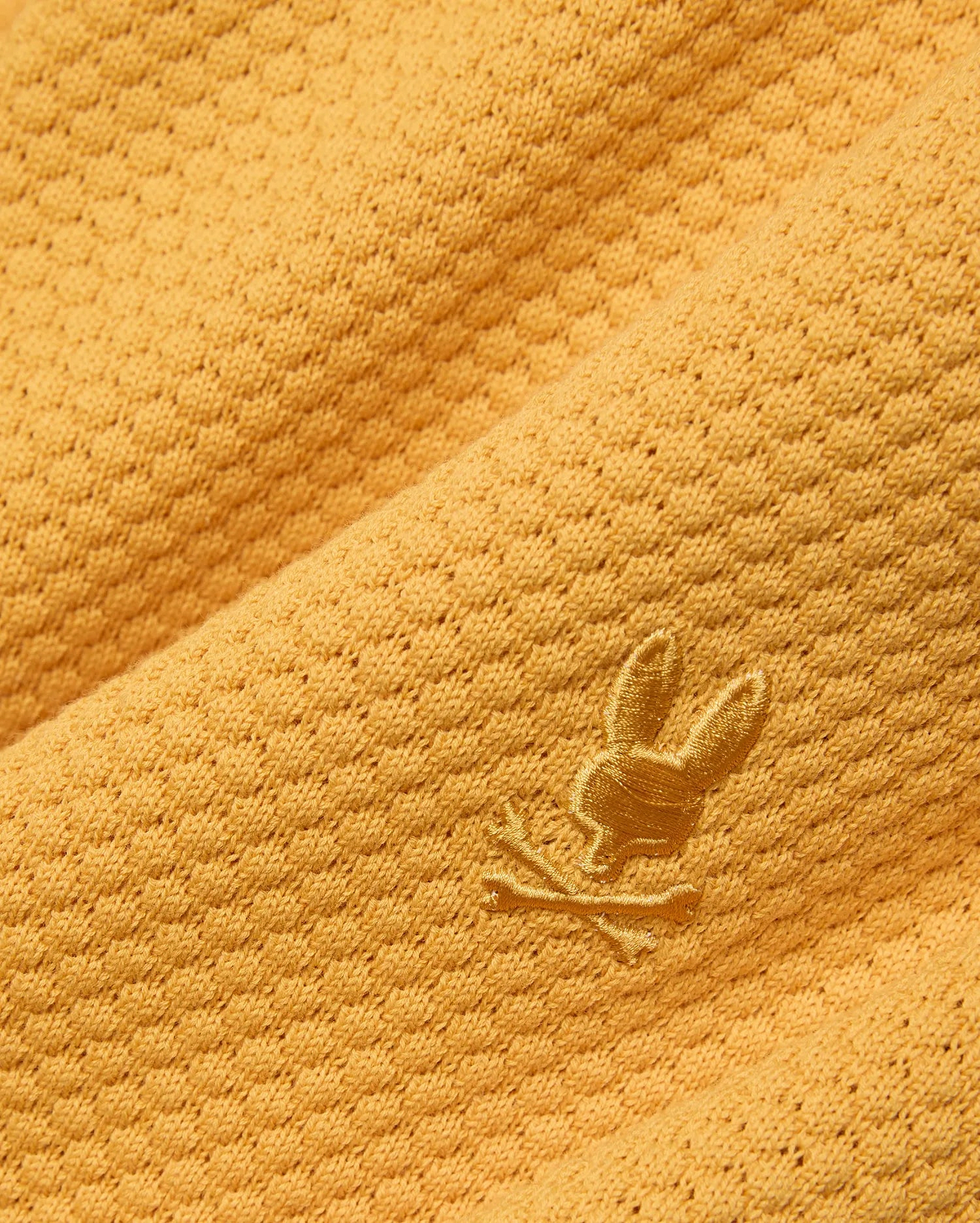 Mustard yellow Mens Devon Knit Short crafted from a textured knit fabric with a subtle geometric pattern, featuring a small, tonal embroidered Psycho Bunny skull logo.