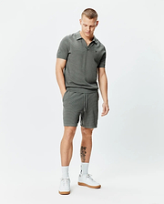 Charcoal grey pique knit polo shirt with small embroidered Psycho Bunny skull logo on left chest and matching Mens Devon Knit Short 7 with drawstring waist, both in a classic fit.