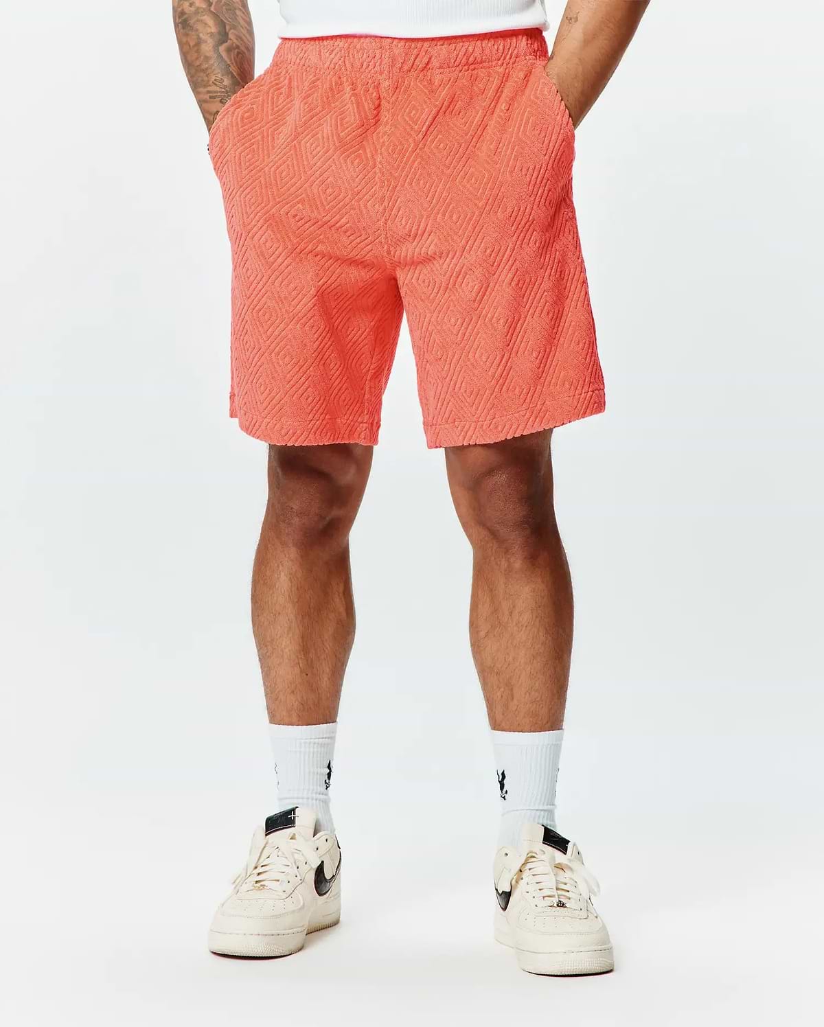Mens Tristan Short in vibrant coral, a relaxed fit short with an all-over raised quilted diamond pattern on soft, textured terry fabric, perfect for refined streetwear. (1)