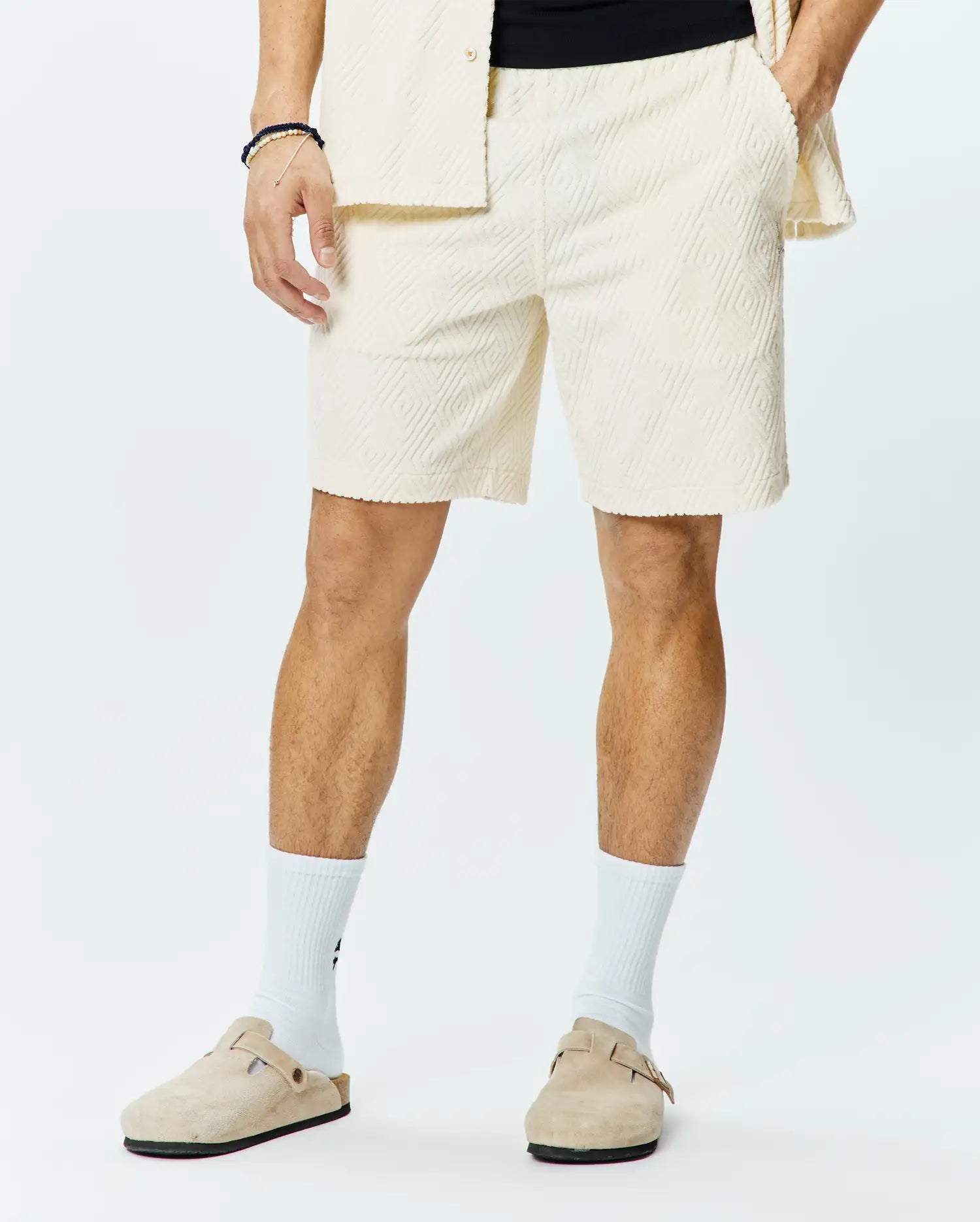 Mens Tristan Short, a premium relaxed fit cream jacquard knit short, showcasing an all-over subtle diamond pattern, comfortable elastic waistband, and practical side pockets for refined streetwear style.