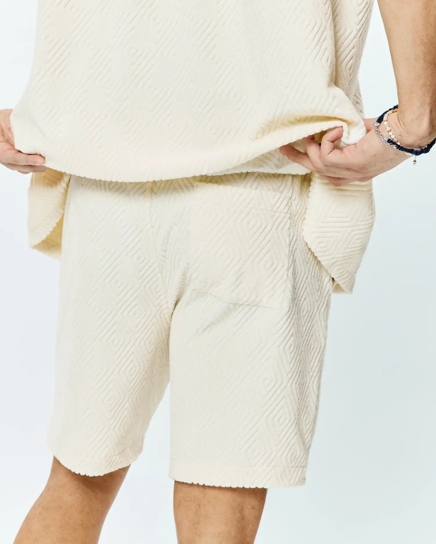 Psycho Bunny Mens Tristan Short in cream, a relaxed fit, soft textured fabric with an all-over embossed geometric diamond pattern.