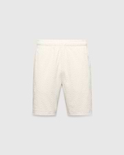 Mens Tristan Short in cream, a relaxed fit short with an all-over raised geometric concentric square pattern on textured fabric, no visible Psycho Bunny logo.