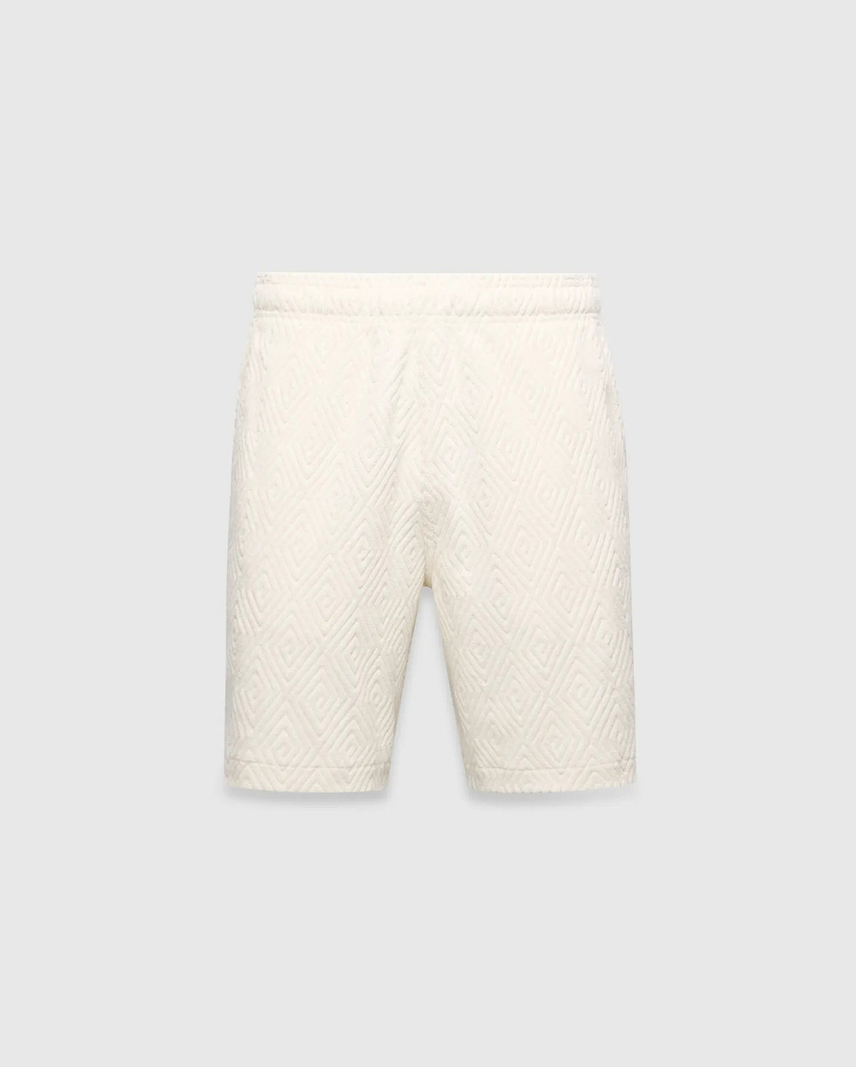 Mens Tristan Short in cream, a relaxed fit short with an all-over raised geometric concentric square pattern on textured fabric, no visible Psycho Bunny logo.