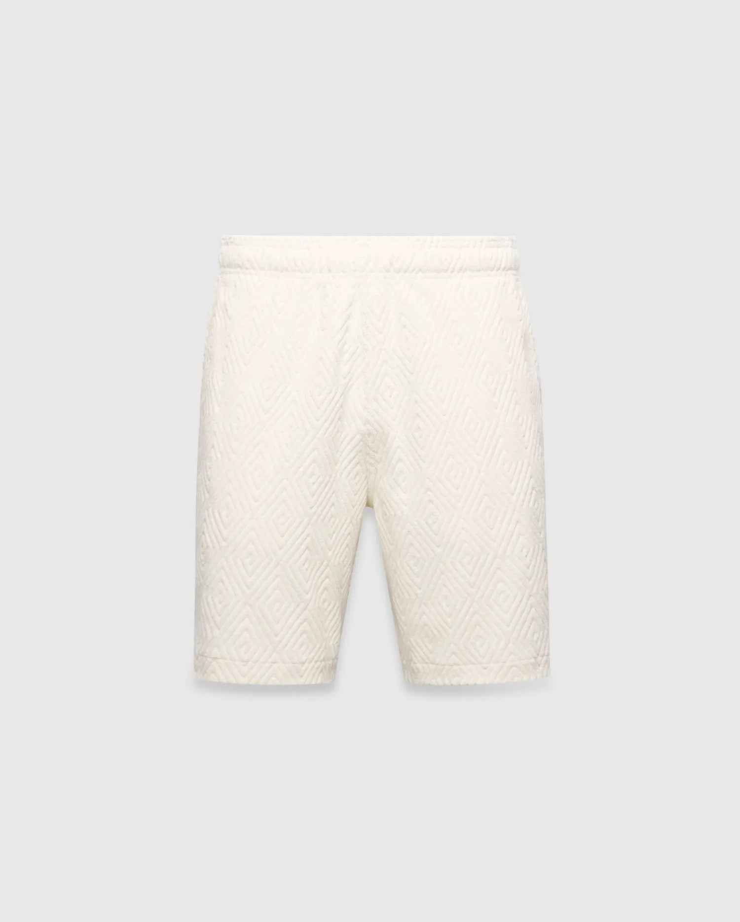 Mens Tristan Short in cream, a relaxed fit short with an all-over raised geometric concentric square pattern on textured fabric, no visible Psycho Bunny logo.