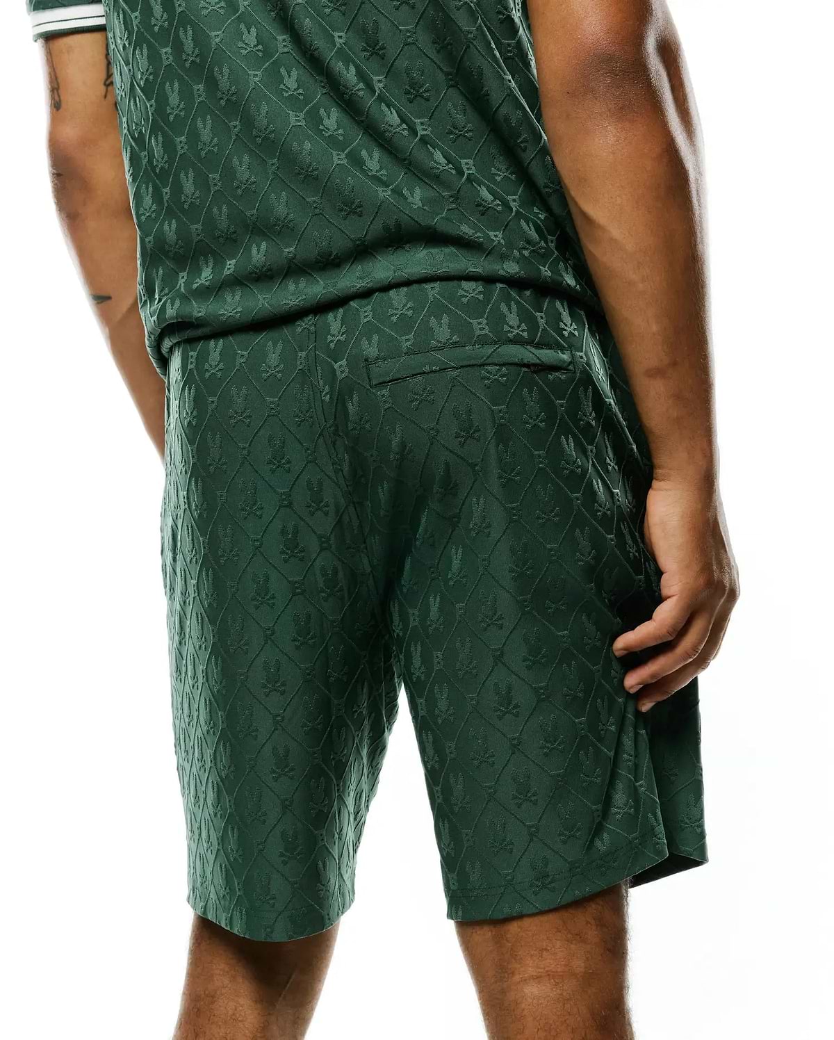 MENS GARRY JACQUARD SWEATSHORT in dark green, featuring a relaxed fit and an all-over jacquard knit pattern of the iconic Psycho Bunny skull logo within a diamond grid.