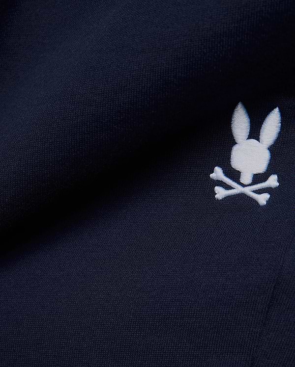 Premium deep navy blue MENS GABE FRENCH TERRY SWEATSHORT, showcasing a soft French terry knit texture and an iconic, crisp white embroidered Psycho Bunny skull logo, embodying refined streetwear style. (7)