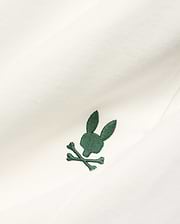 Cream Mens Gabe French Terry Sweatshort, featuring a small, intricately embroidered dark green Psycho Bunny skull and crossbones logo on soft French terry fabric. (6)