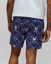 Mens Luke Swim Trunk in navy blue with an all-over ornate floral and paisley pattern featuring repeated Psycho Bunny skull logos with pink ears, crafted from smooth, quick-dry fabric in a classic fit.