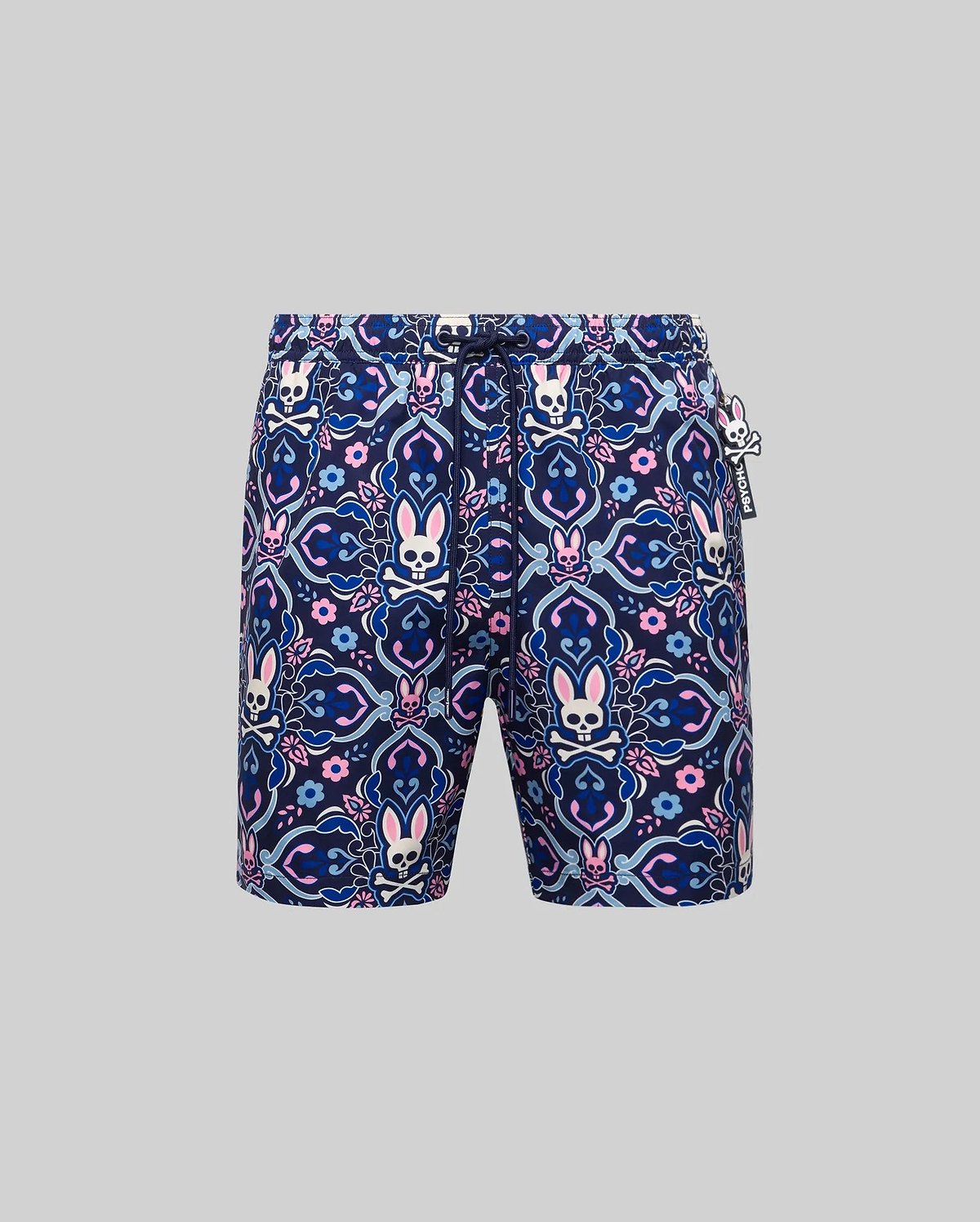 Mens Luke Swim Trunk in navy blue with an allover pink, light blue, and white intricate paisley, floral, and Psycho Bunny skull pattern. Features a drawstring waist and a small rubberized Psycho Bunny tag.