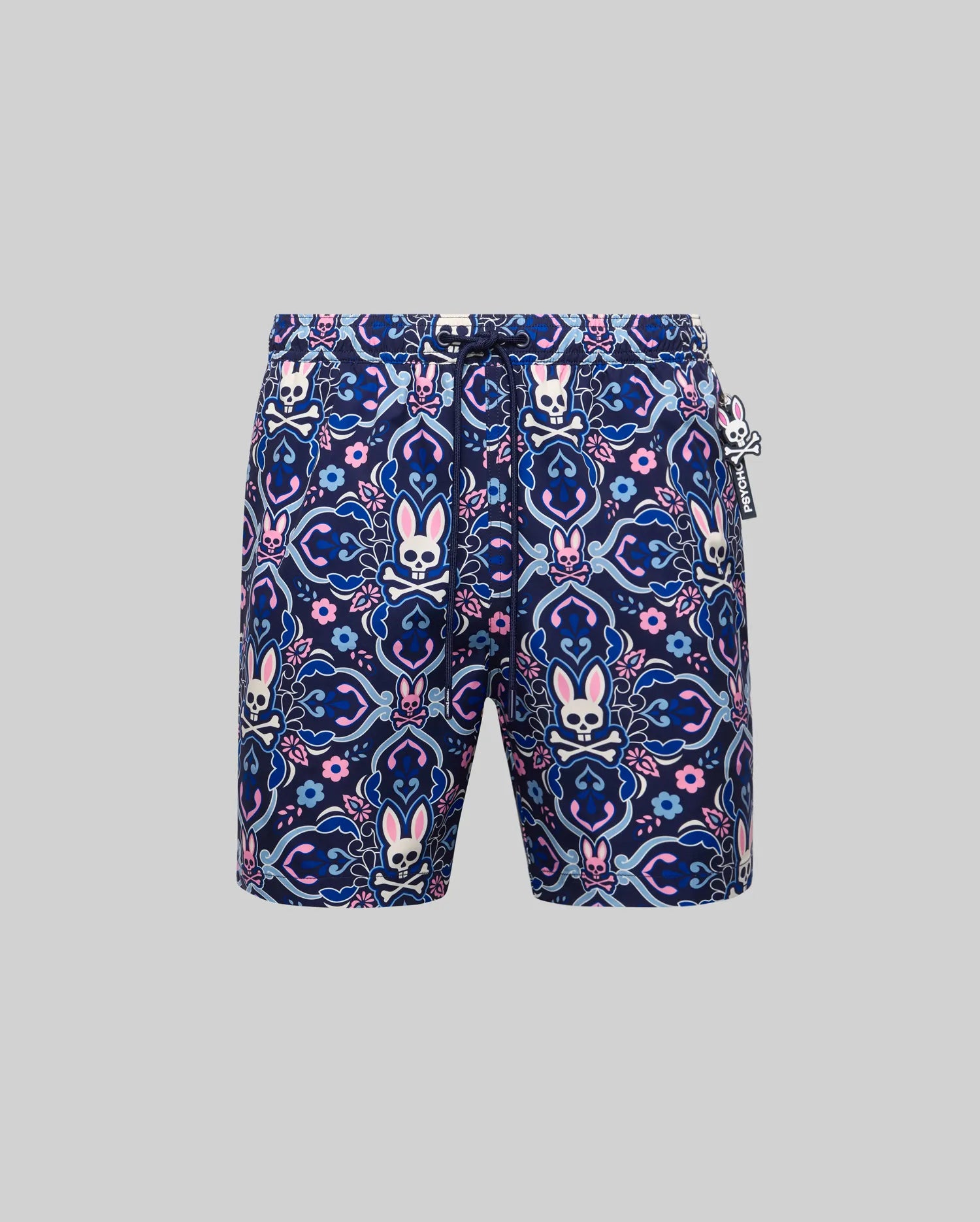 Mens Luke Swim Trunk in navy blue with an allover pink, light blue, and white intricate paisley, floral, and Psycho Bunny skull pattern. Features a drawstring waist and a small rubberized Psycho Bunny tag.
