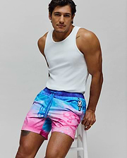 Mens Caspian Swim Trunk with a vibrant blue to pink tie-dye gradient, subtle skull pattern, dark blue waistband, and a Psycho Bunny logo charm on the drawstring with vertical branding.