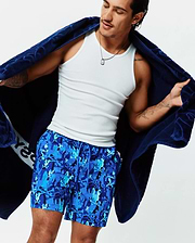 Mens Tanner Swim Trunk in a vibrant multi-tone blue camouflage pattern featuring an all-over Psycho Bunny skull logo print. This classic fit, quick-dry swim trunk has an adjustable drawstring waist.