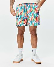 Mens Tanner Swim Trunk featuring a vibrant all-over print of colorful Psycho Bunny skull logos, crossbones, and abstract shapes, with a blue drawstring and a classic fit.