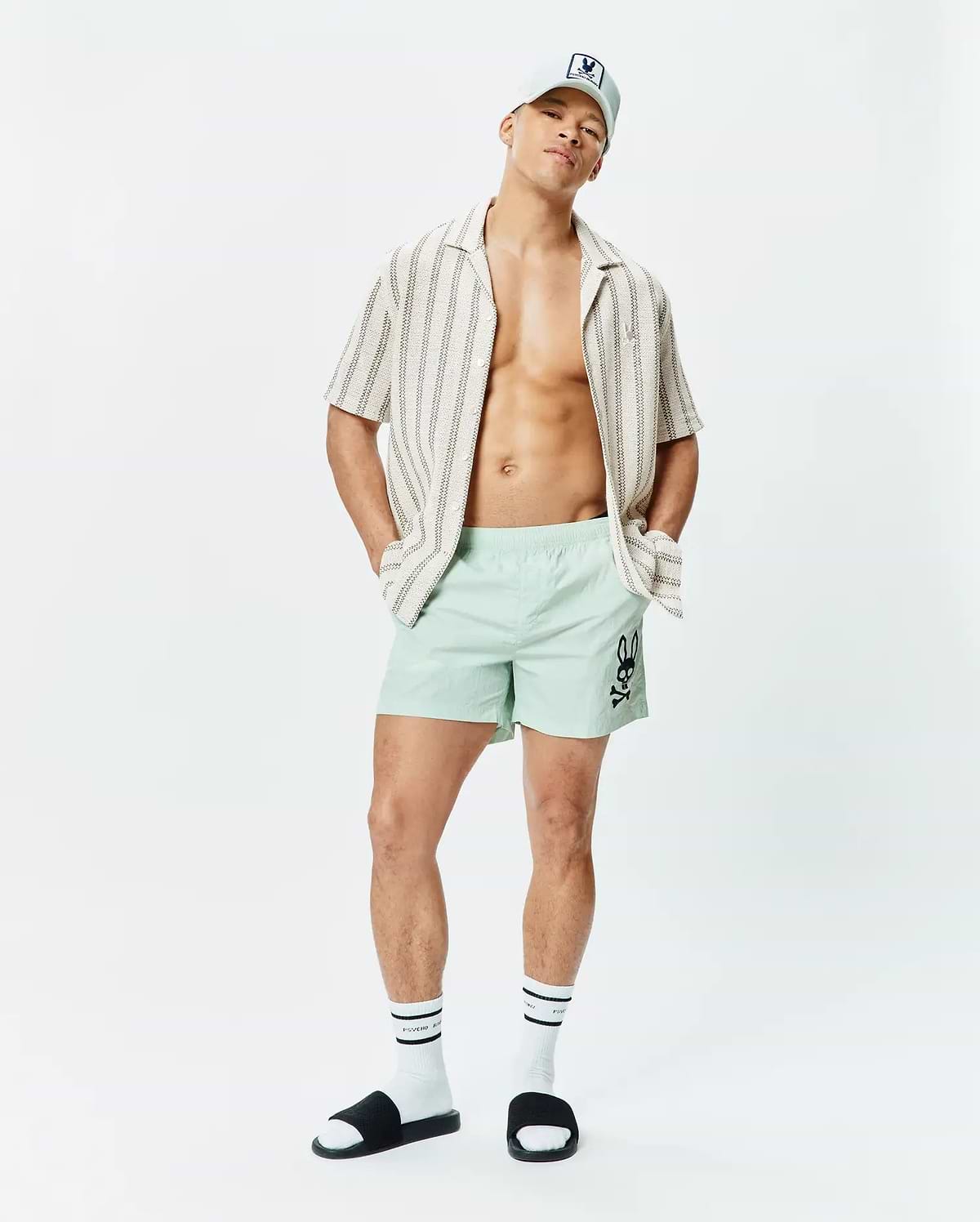 Mens Neo Swim Trunk 5 in mint green, featuring a classic fit and smooth, quick-dry fabric, with a large black Psycho Bunny skull logo prominently on the left thigh. (4)