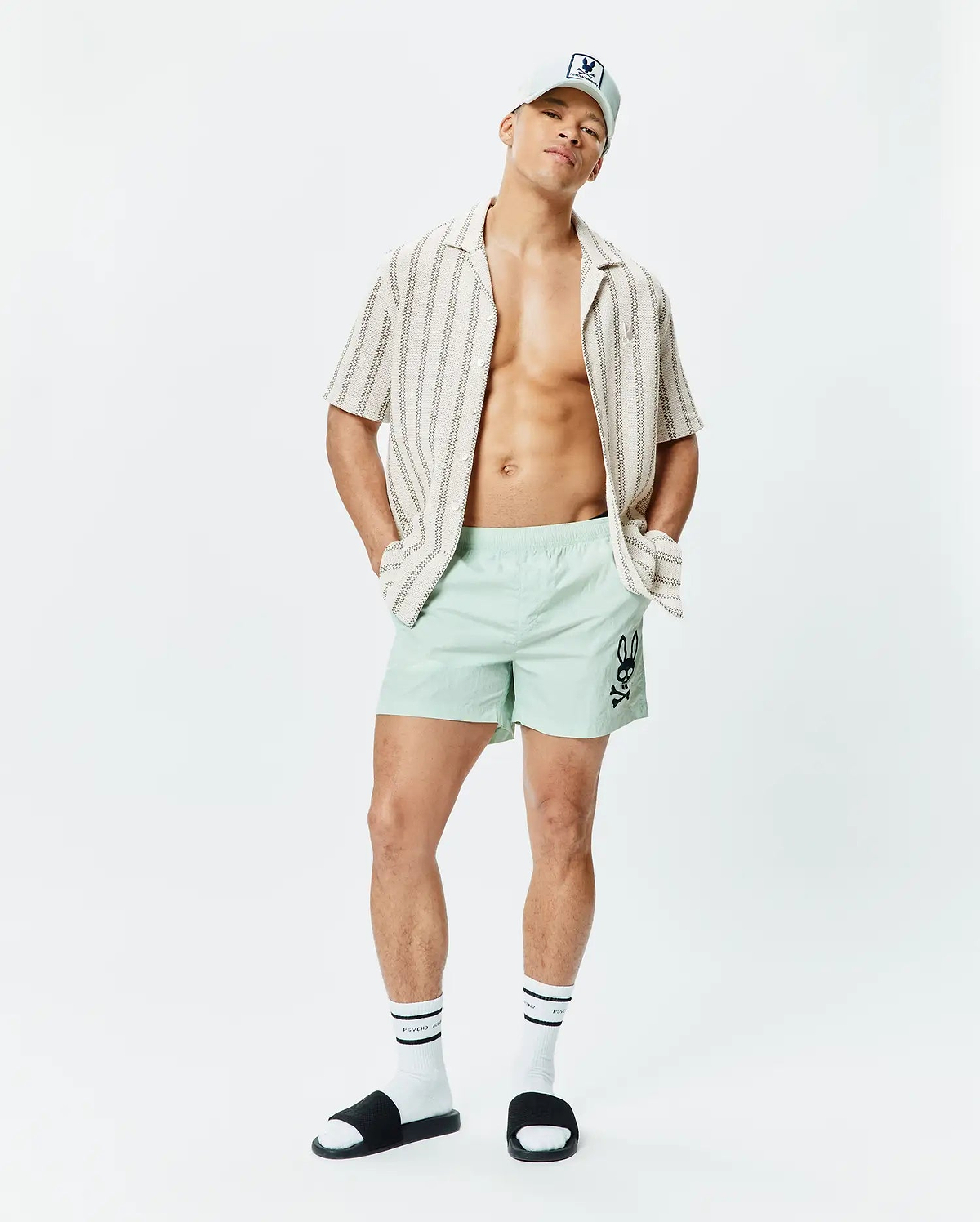 Mens Neo Swim Trunk 5 in mint green, featuring a classic fit and smooth, quick-dry fabric, with a large black Psycho Bunny skull logo prominently on the left thigh. (4)