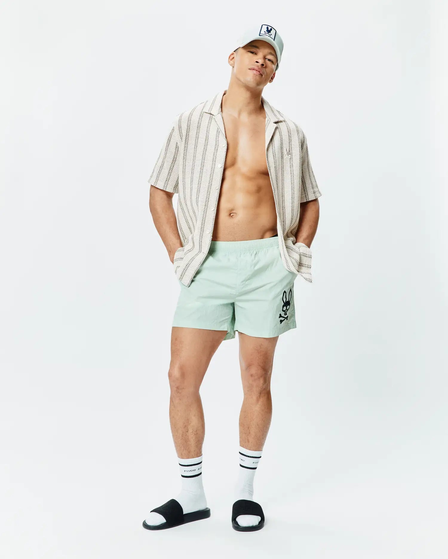 Mens Neo Swim Trunk 5 in mint green, featuring a classic fit and smooth, quick-dry fabric, with a large black Psycho Bunny skull logo prominently on the left thigh. (4)