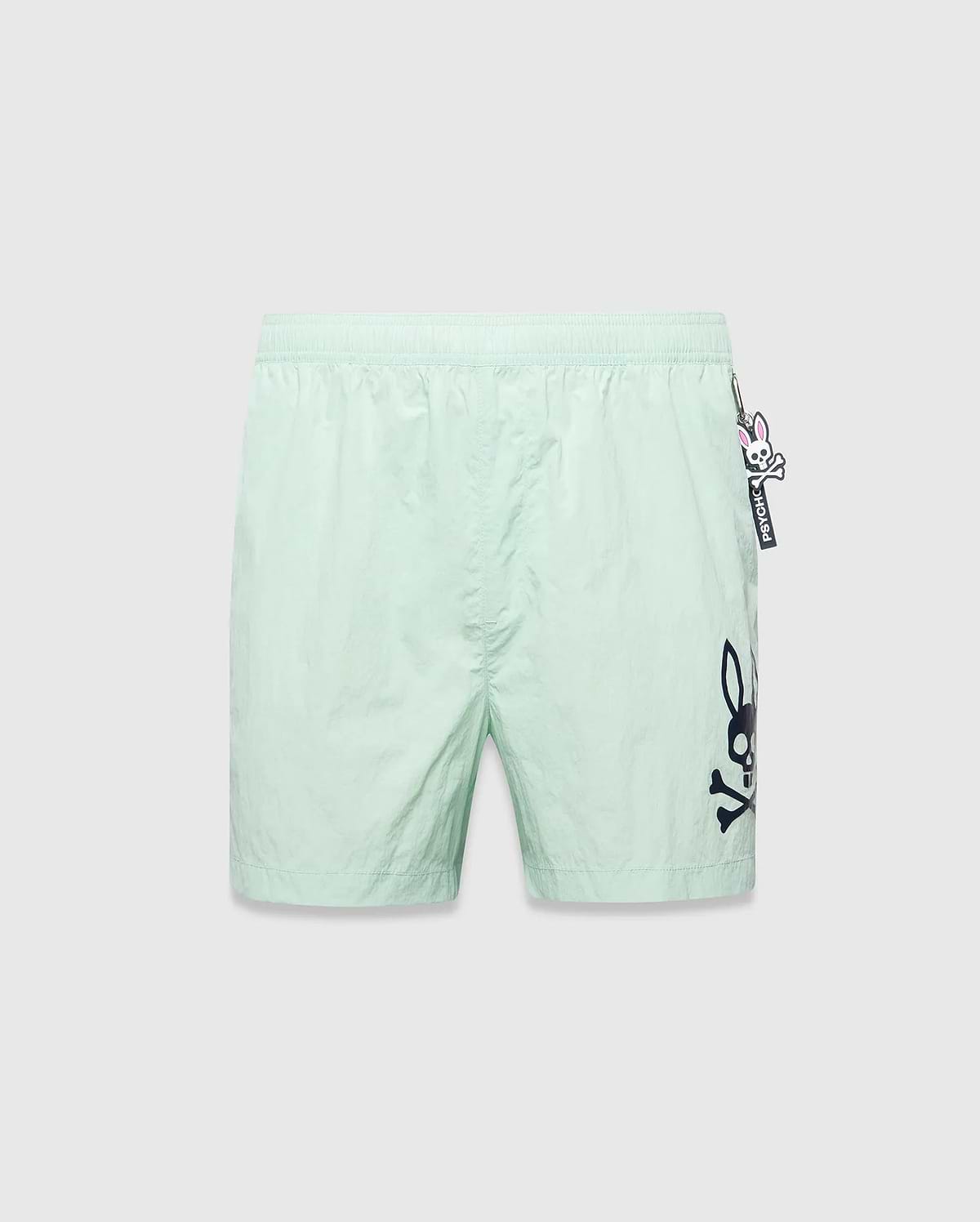 Mens Neo Swim Trunk 4, mint green, relaxed fit, smooth nylon fabric, with a large dark blue Psycho Bunny skull logo print on the right leg and a small Psycho Bunny keychain on the left hip. (5)