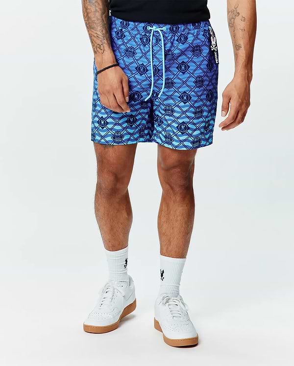 Tobias Gradient Swim Trunk in a vibrant blue gradient, featuring an all-over Psycho Bunny skull logo and wavy line pattern. This classic fit swim trunk has a smooth, quick-dry fabric, light blue drawstring, and a small Psycho Bunny brand tag on the side.