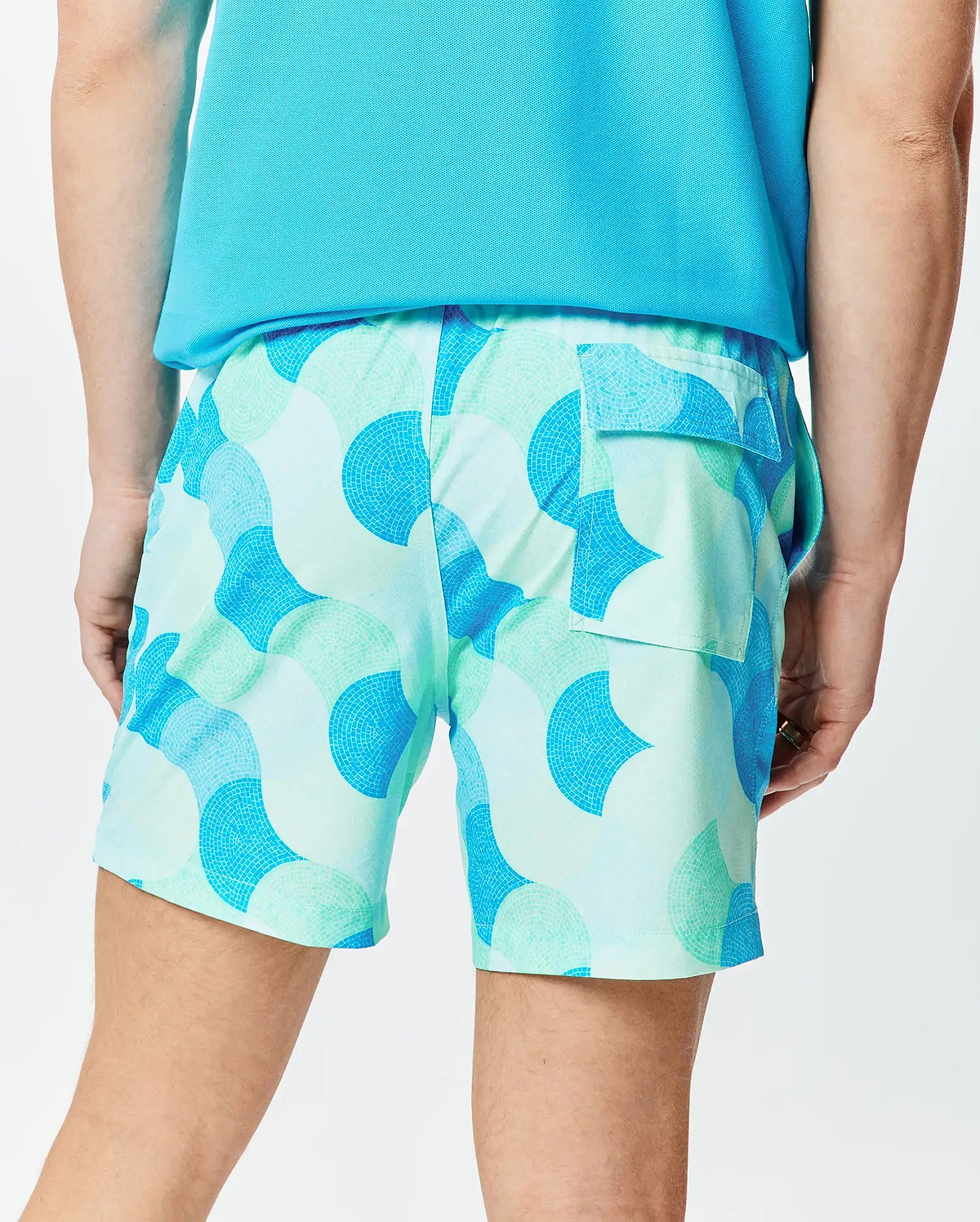Mens Ethan Swim Trunk 6, a relaxed fit swim short in light blue and mint green with a vibrant mosaic-style curved pattern and a practical back flap pocket.