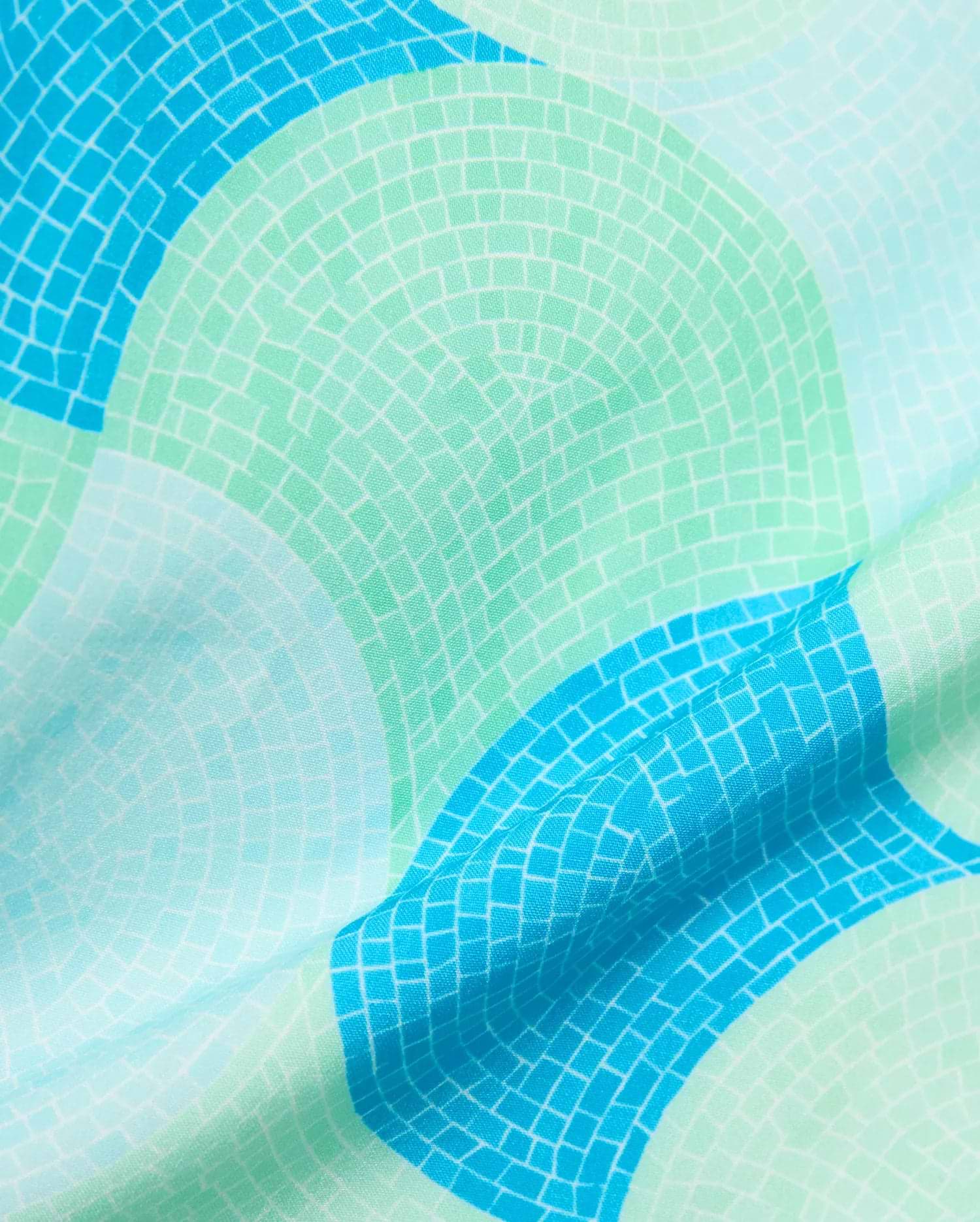 Mens Ethan Swim Trunk 6 featuring a vibrant mosaic-style pattern in shades of turquoise, sky blue, and mint green, on a smooth, lightweight fabric.