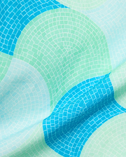 Mens Ethan Swim Trunk 6 featuring a vibrant mosaic-style pattern in shades of turquoise, sky blue, and mint green, on a smooth, lightweight fabric.