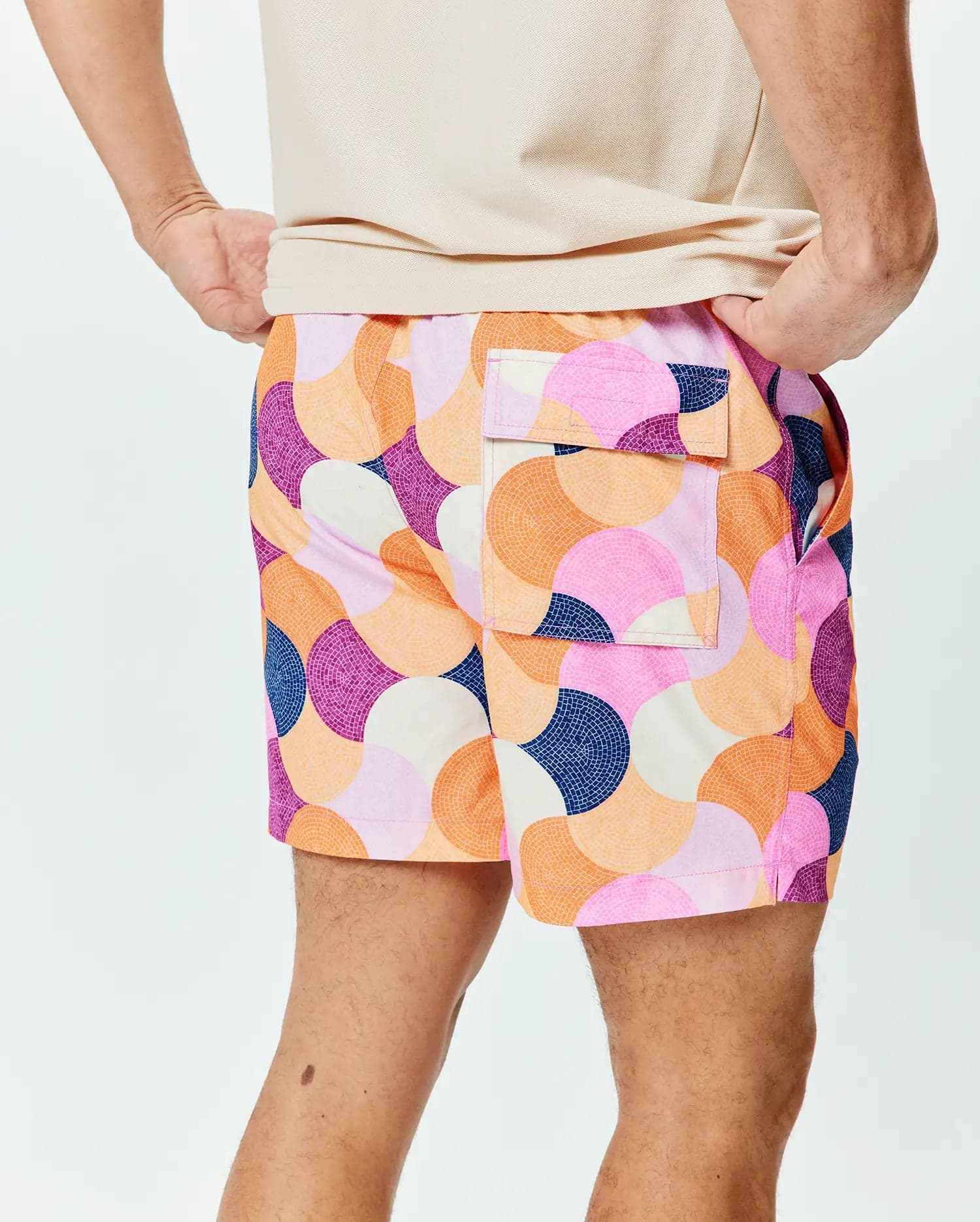 Mens Ethan Swim Trunk 6 featuring a vibrant mosaic-like circular pattern in pink, orange, purple, navy, and cream, with a relaxed fit, smooth quick-dry fabric, and a back flap pocket.