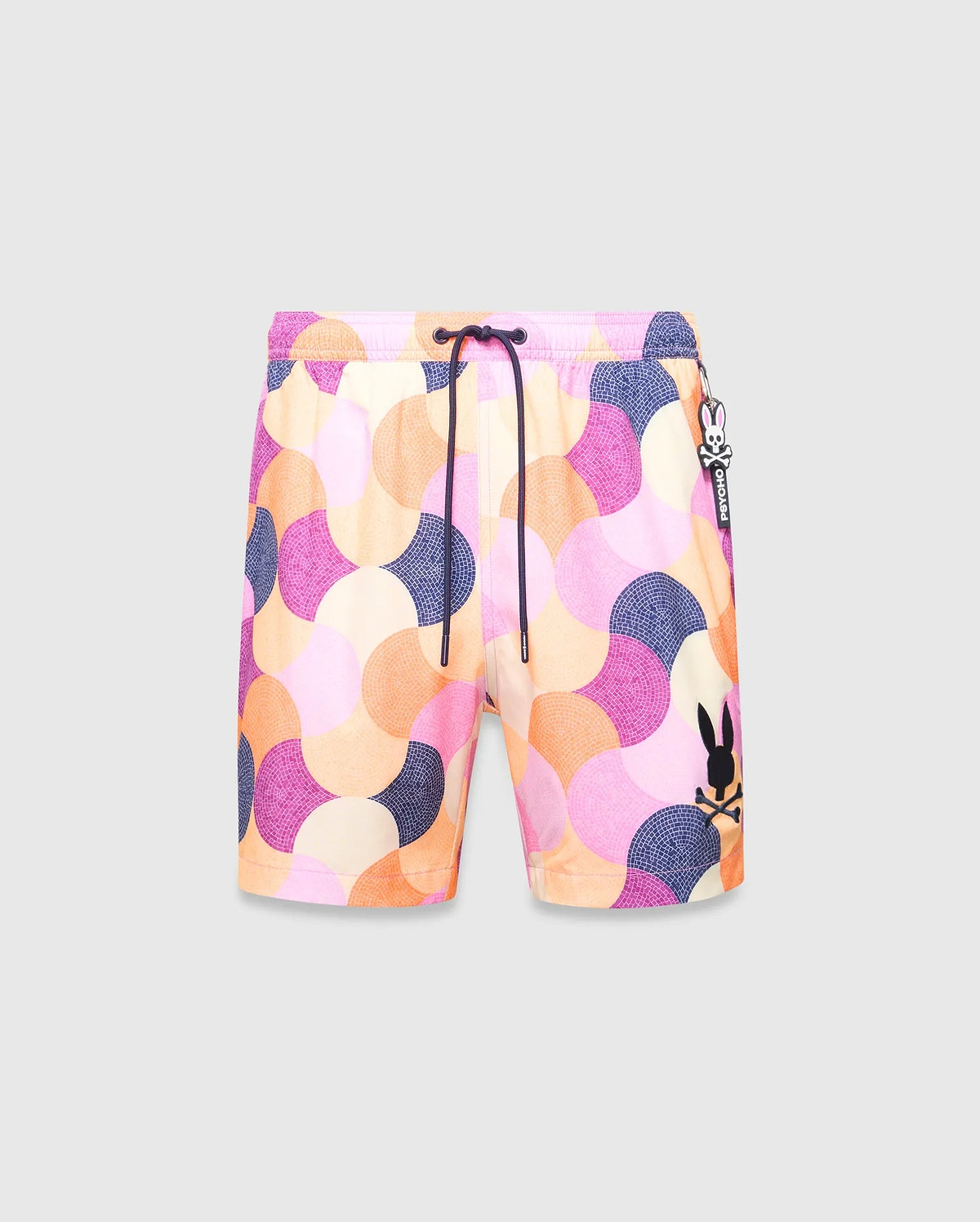 Mens Ethan Swim Trunk 6 with a vibrant mosaic pattern in pink, orange, purple, and cream. Features a black drawstring, large embroidered black Psycho Bunny skull logo on the left leg, and a Psycho Bunny tag.