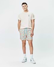 Cream jersey t-shirt with small embroidered blue-orange Psycho Bunny logo on chest, paired with Mens Frank Swim Trunk 6, featuring a vibrant blue and orange geometric tile pattern with integrated bunny skull motifs. (4)