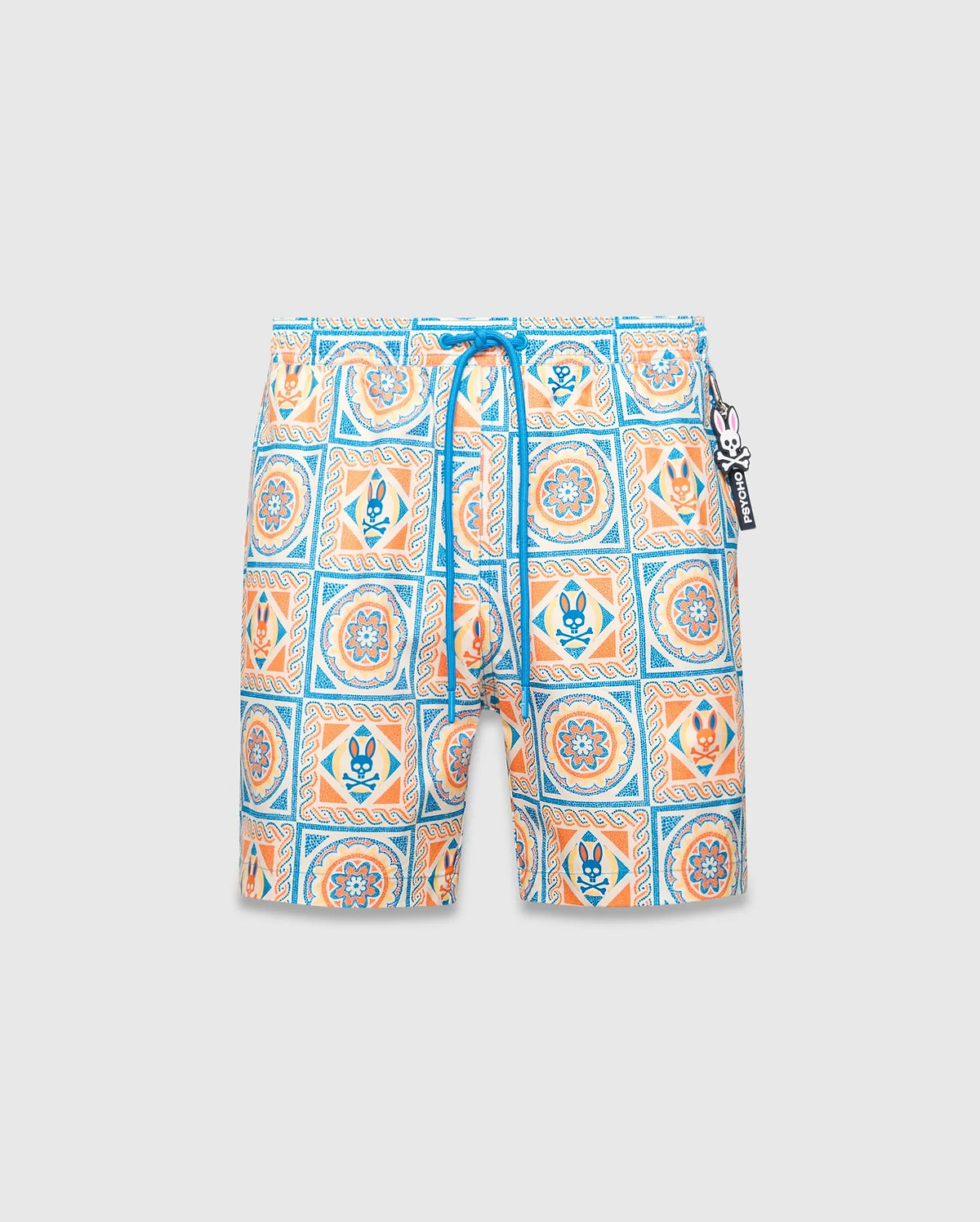 Mens Frank Swim Trunk 6, featuring an all-over white, blue, orange, and yellow tiled pattern with floral designs and small Psycho Bunny skull logos, complete with a blue drawstring and logo charm. (5)