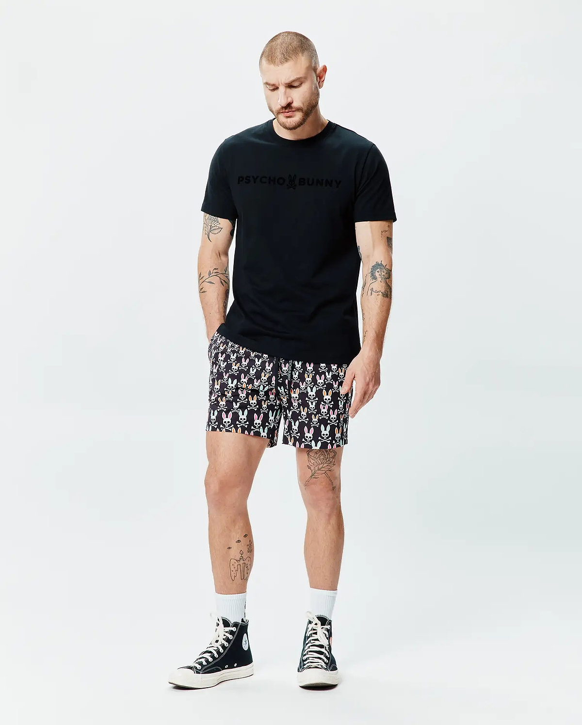 Black classic fit jersey t-shirt with a tonal, raised Psycho Bunny chest logo, paired with Mens Byron Swim Trunk 6 featuring an all-over vibrant bunny skull print. (4)