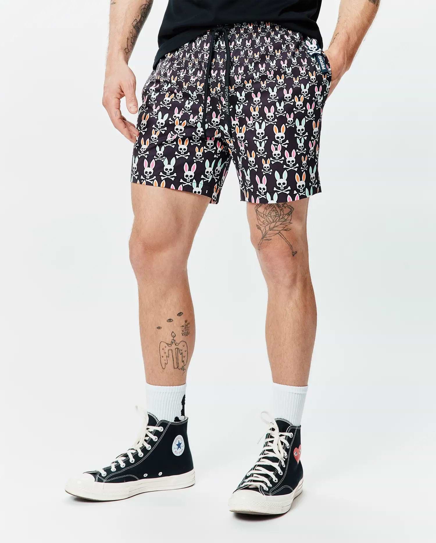 Mens Byron Swim Trunk 6, black with a vibrant all-over multicolored Psycho Bunny skull and crossbones print, classic fit, smooth fabric, and a small logo tag on the pocket. (1)