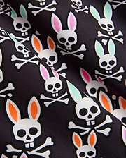 Mens Byron Swim Trunk 6 with a black smooth fabric featuring an all-over white bunny skull and crossbones print, accented with vibrant pink, mint green, and orange ears. (6)