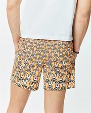 Mens Byron Swim Trunk 6 in vibrant orange, featuring an all-over print of white Psycho Bunny skull logos with pink and light blue ears, crafted from smooth, quick-dry fabric for a relaxed fit.