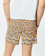 Mens Byron Swim Trunk 6 in vibrant orange, featuring an all-over print of white Psycho Bunny skull logos with pink and light blue ears, crafted from smooth, quick-dry fabric for a relaxed fit.